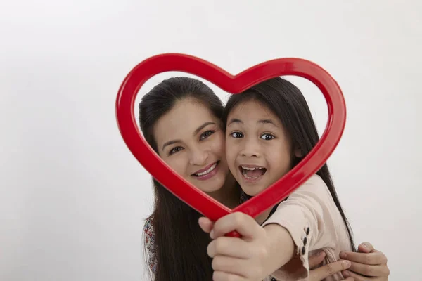Malay Mother Daughter Holding Red Heart Shape Picture Frame Facing — Stock Photo, Image