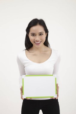 bir beyaz tahta tutan malay kadın