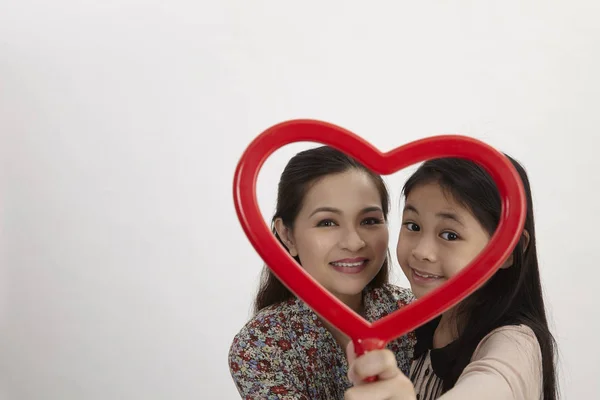 Malay Mother Daughter Holding Red Heart Shape Picture Frame Facing — Stock Photo, Image