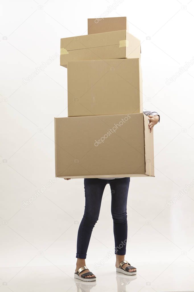 woman carring stack of brown boxes she hiding behind boxes