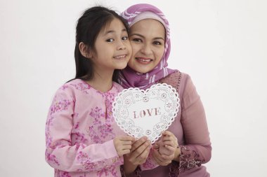 bir kalp şekli afiş bir arada tutan kızı ile Malay kadınla 