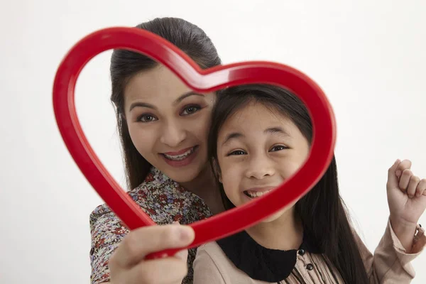 Malay Mother Daughter Holding Red Heart Shape Picture Frame Facing — Stock Photo, Image