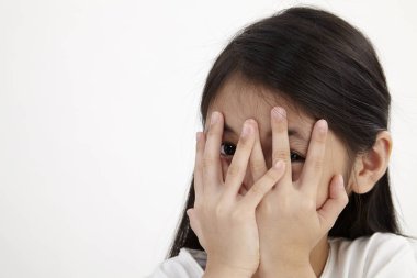 beyaz zemin üzerine yüzünü kaplayan kız