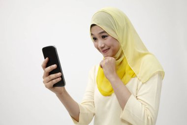 Malay kadın holding akıllı kullanarak telefon kendi kendine portre