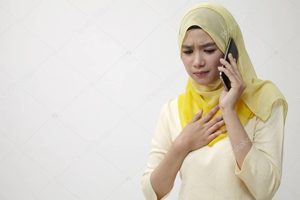 malay woman on the line with sad expression