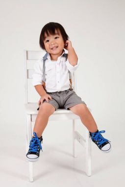 Çinli çocuk ifade merak ile büyük dışkı oturan