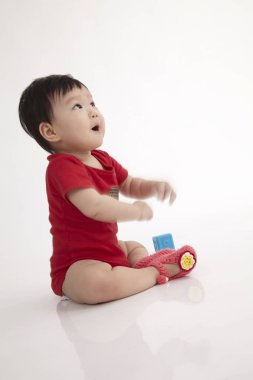 Çinli bebek beyaz arka plan üzerinde oturan profili