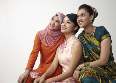 three Malaysian young beautiful girls posing in studio  clipart