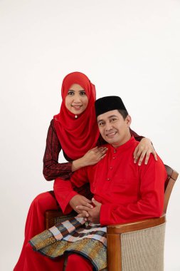 husband sitting and his wife by the side clipart
