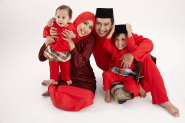 malay family sittng on the white background clipart
