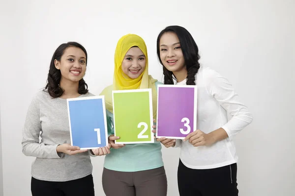 Três Multi Racial Malaysian Segurando Livro Impresso 123 — Fotografia de Stock