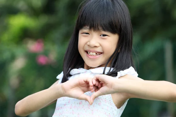 close up of chinese girl with hand gesture love