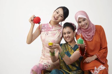 three Malaysian young beautiful girls posing in studio  clipart