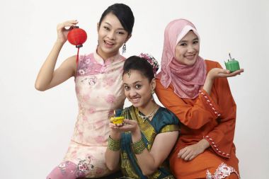 three Malaysian young beautiful girls posing in studio  clipart