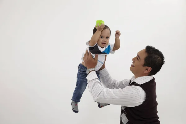 malay family man playing with his child
