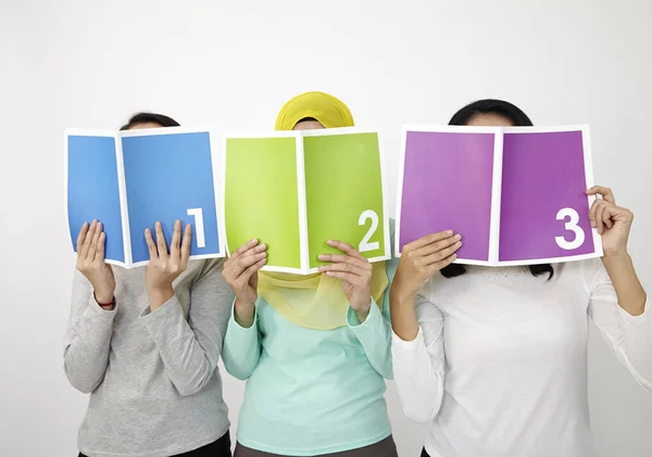 Three Multi Racial Malaysian Holding Book Printed 123 — Stock Photo, Image