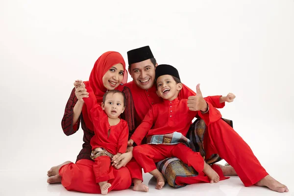 malay family sittng on the white background