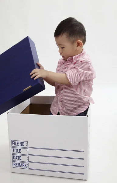 chinese boy playing with white box