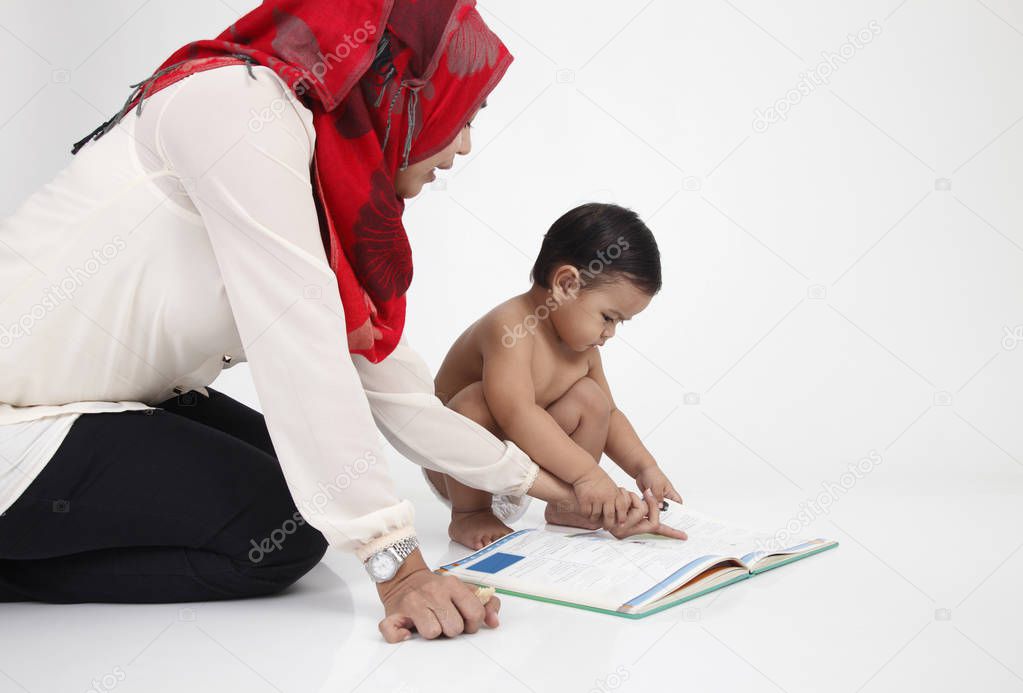 mother reading book together with her child