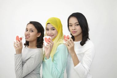 Üç multi ırksal Malezya holding Kupası kameraya bakarak aşk