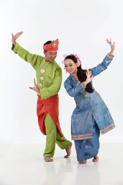 malay couple in traditional costumes posing in studio clipart