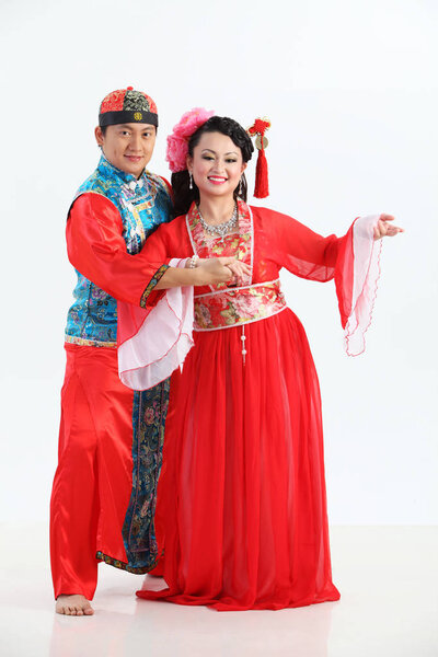 Chinese couple with traditional costumes posing in studio 
