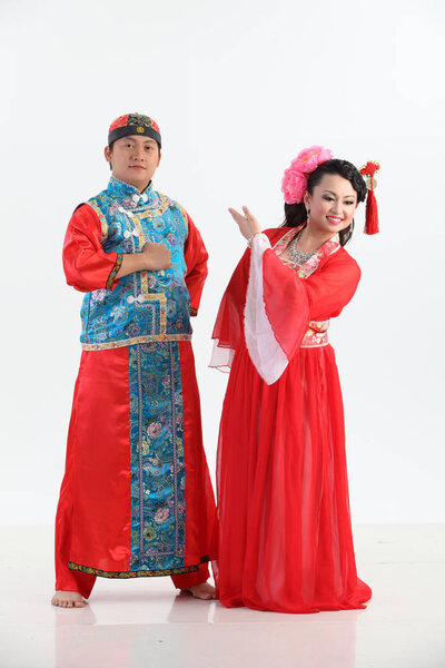 Chinese couple with traditional costumes posing in studio 