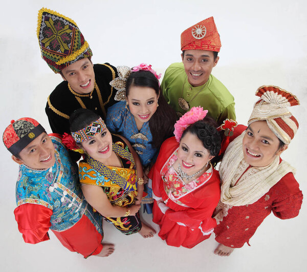 Malaysian people in traditional clothes posing in studio