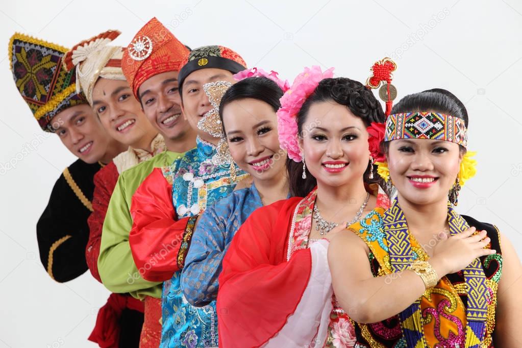 Malaysian people in traditional clothes posing in studio