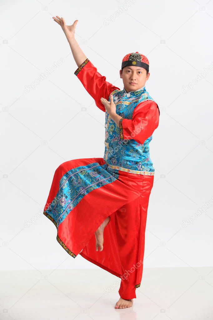 chinese man in traditional costume posing in studio 