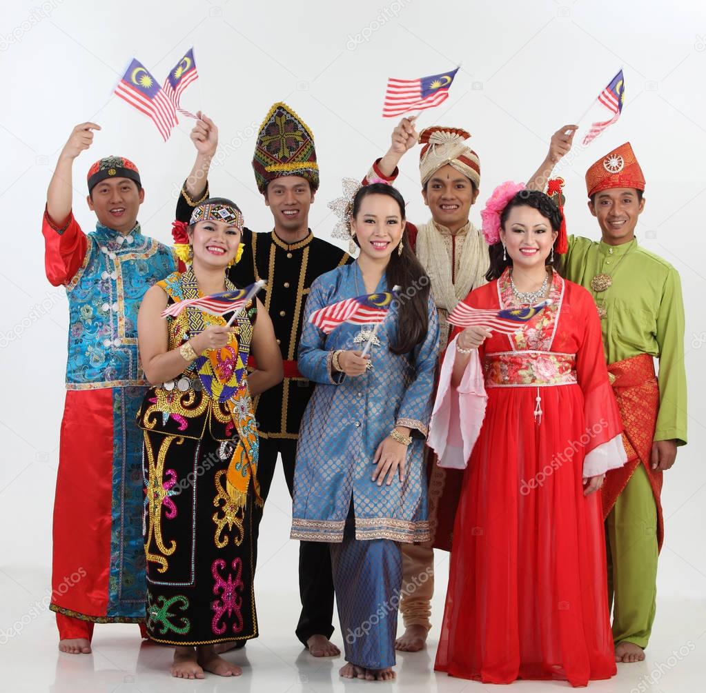 Malaysian people in traditional clothes posing in studio