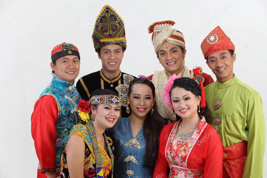 Malaysian people in traditional clothes posing in studio