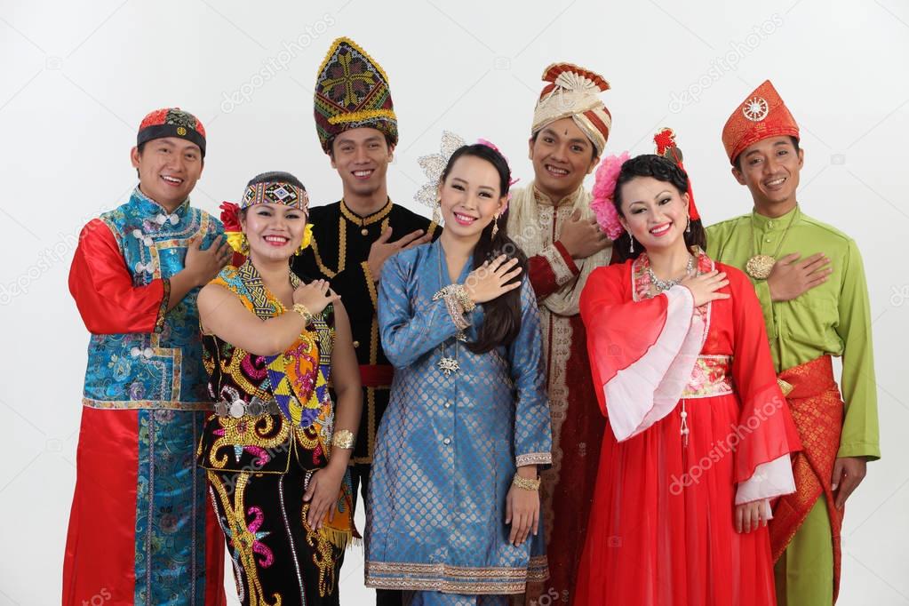 Malaysian people in traditional clothes posing in studio