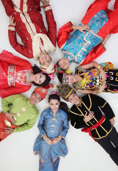 Malaysian people in traditional clothes posing in studio