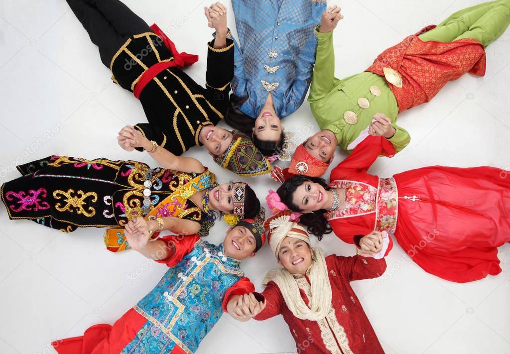 Malaysian people in traditional clothes posing in studio