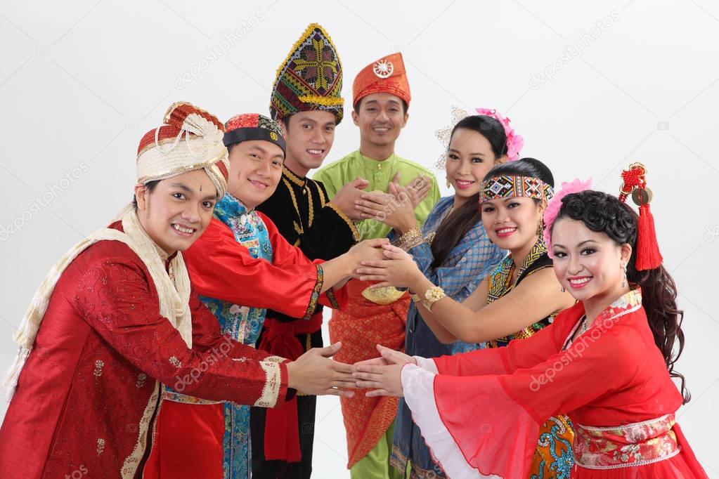 Malaysian people in traditional clothes posing in studio