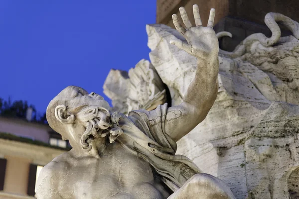 Italy, Rome, Navona Square, one of the marble statues of the Four Rivers Fountain at sunset (Bernini, 1648 a.C.) — Stock Photo, Image