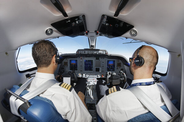 Italy; 26 July 2010, pilots in an flying airplane's cockpit - EDITORIAL