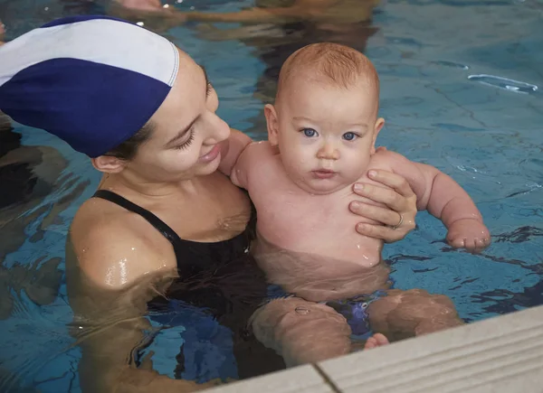 Italien, ung mamma och hennes nyfödda gossebarn i en pool — Stockfoto