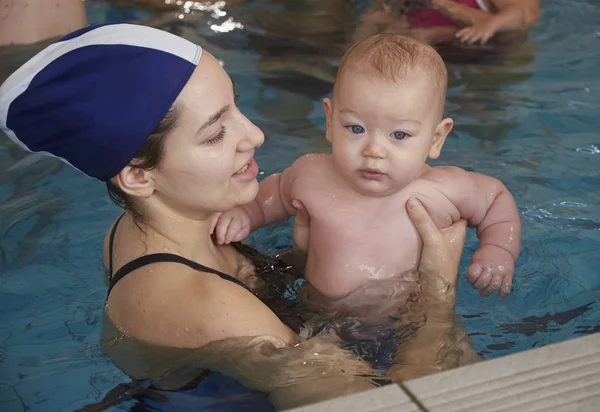 Italien, ung mamma och hennes nyfödda gossebarn i en pool — Stockfoto