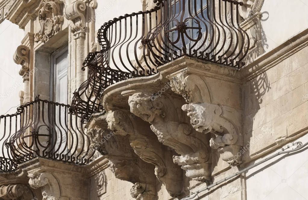 Italy, Sicily, Scicli (Ragusa province), the Baroque Beneventano Palace facade with balconies ornamental statues (18th Century a.C.)