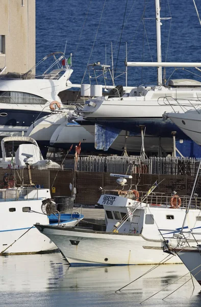 Italy, Sicily, Mediterranean sea, Marina di Ragusa; 19 June 2017, wooden fishing boats and luxury yachts in the port - EDITORIAL — Stock Photo, Image