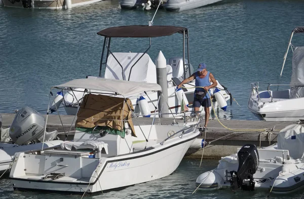 Italy, Sicily, Mediterranean sea, Marina di Ragusa; 5 September 2017, fisherman washing his motor boat in the port - EDITORIAL — Stock Photo, Image