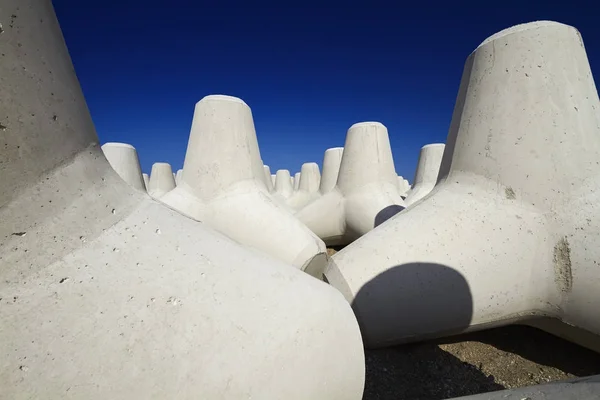 Włochy, Sycylia, prowincja Mesyna, betonowe czworonożki na plaży w pobliżu portu w budowie — Zdjęcie stockowe