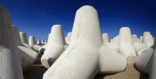 Italy, Sicily, Messina province, concrete tetrapods on the beach near a port under construction — Stock Photo, Image