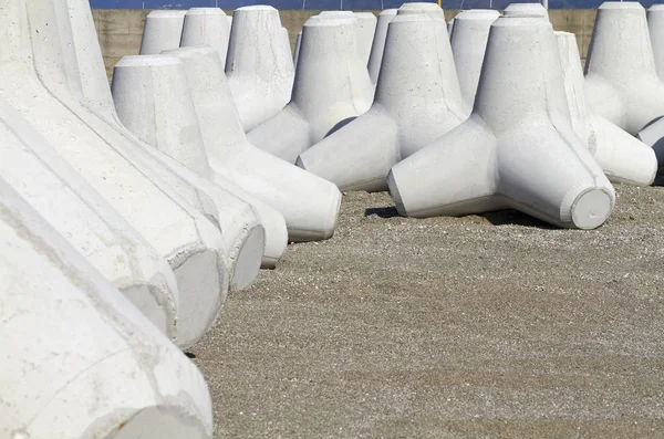 Италия, Сицилия, провинция Мессина, бетонные тетраподы на пляже рядом с строящимся портом — стоковое фото