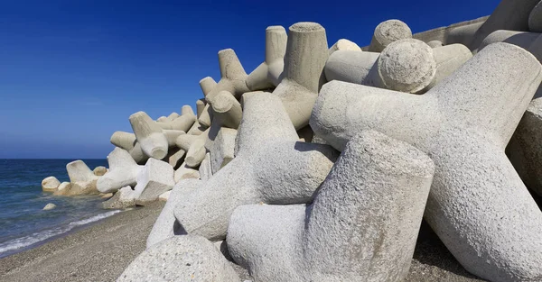 Italie, Sicile, province de Messine, tétrapodes de béton sur la plage près d'un port en construction — Photo