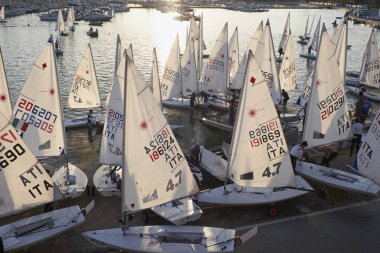 Italy, Sicily, Mediterranean sea, Marina di Ragusa; 3 November 2017, people and sailing dinghies in the port - EDITORIAL clipart