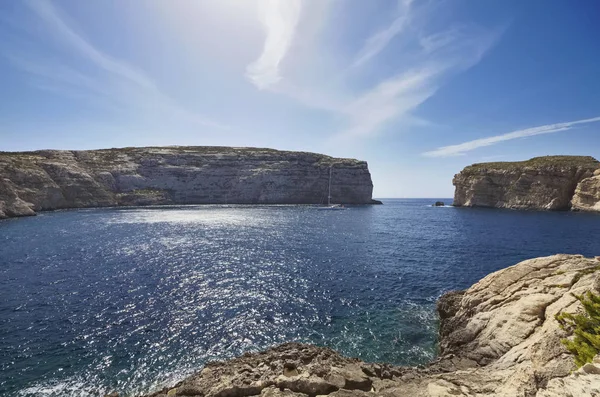 Malta Island, Gozo, view of sailing boats in the Dweira Lagoon and the rocky coastline near the Azure Window Rock