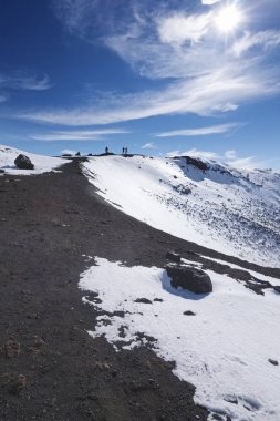 Italy, Sicily, Catania Province, volcano Etna, people at one of the Silvestri craters with snow